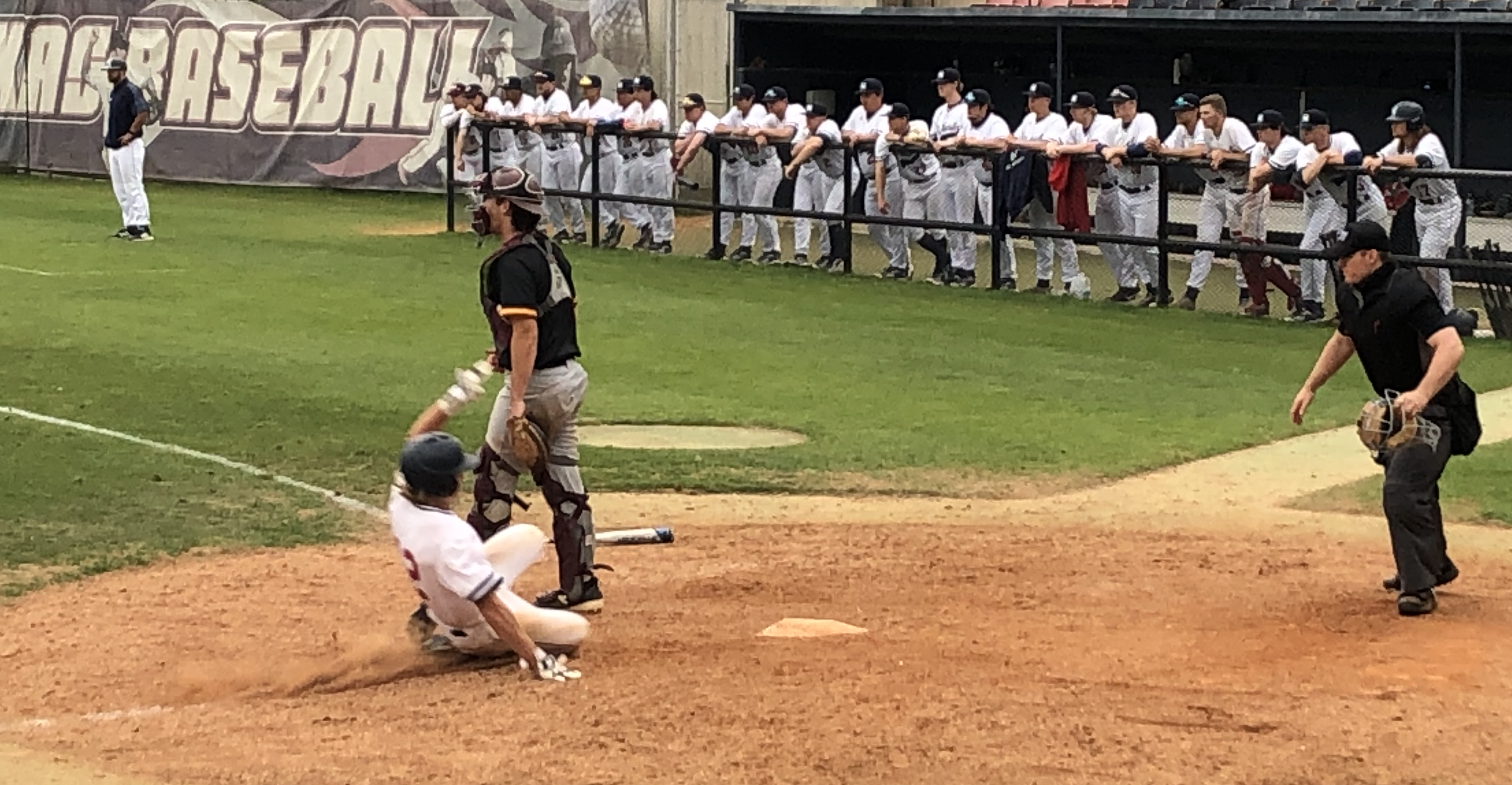 baseball player sliding home