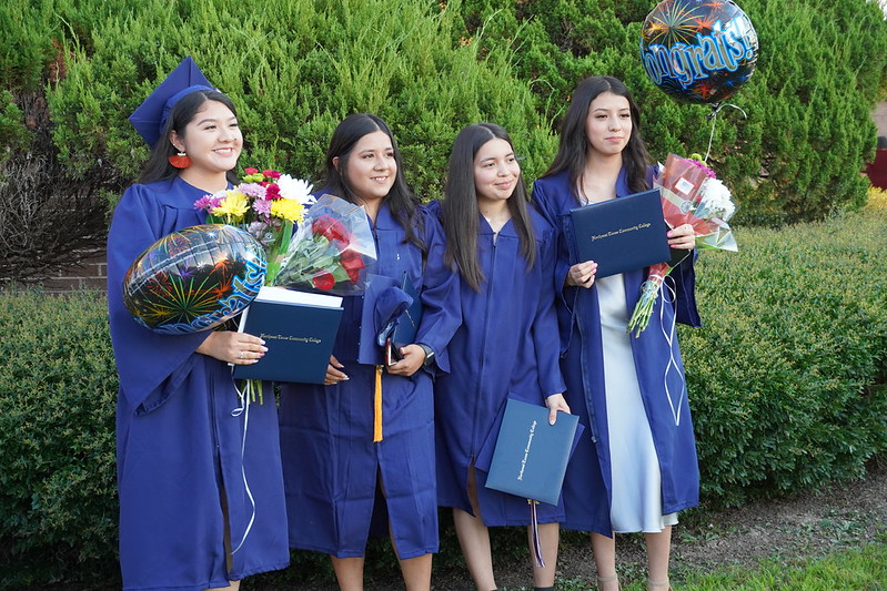 female graduates posing after ceremony