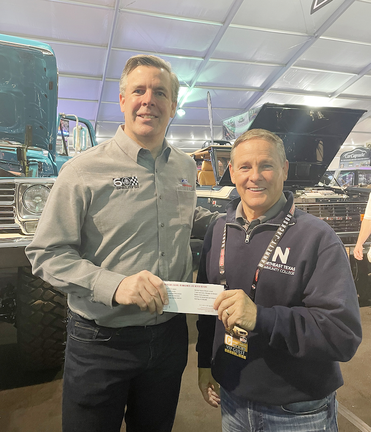 Aaron shelby presents check to Jon McCullough