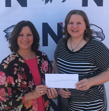 Christi Denney presenting scholarship check to Nita May