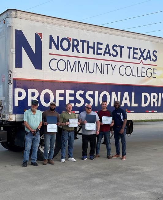 CDL grads in front of truck