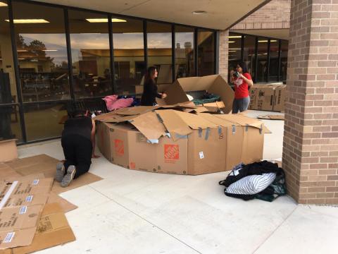 students building box shelters