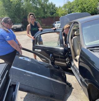 automotive students working on a car