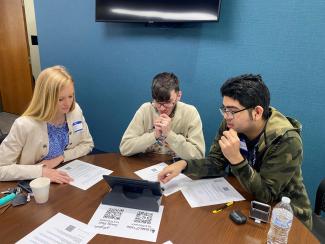 three students judging science fair