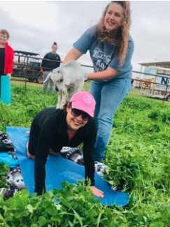 girls doing goat yoga