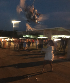 blurry photo of girl whacking pinata