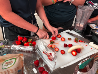 girls chopping strawberries