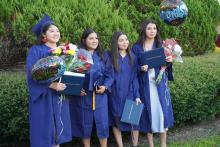 female graduates posing after ceremony