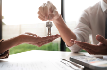 real estate agent handing keys to new homeowner