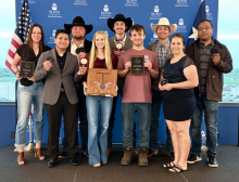 students posing with awards