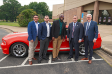 group with Treviño in front of Shelby Mustang