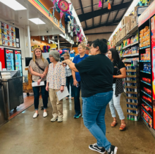 employee shows students around Super Bueno